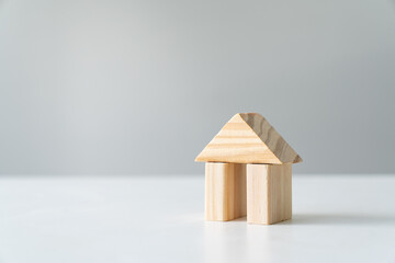 Wooden house block on white background for real estate property industry