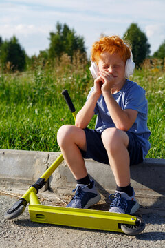 Boy squinting and listening to music