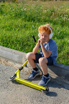 Kid listening to music in summer