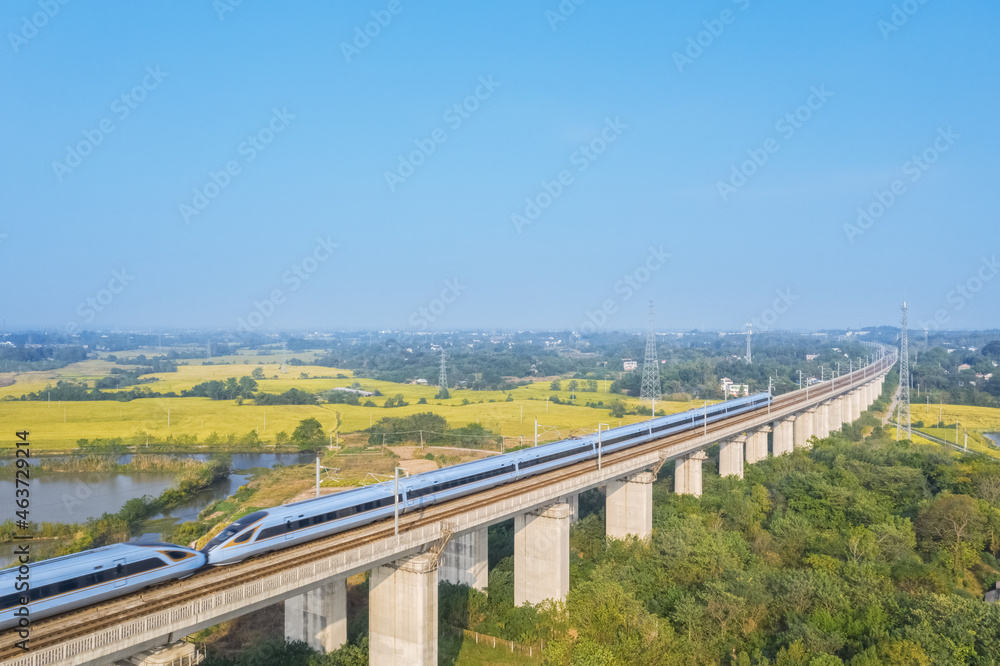 Poster aerial view of high speed trains in rural autumn landscape