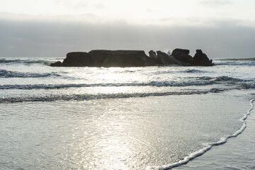 Big Rocks in the Sea breaking the waves in the coast during a sunny day