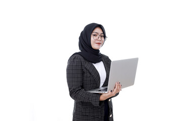 Young Asian Islam woman is smilling when holding and working on laptop computer isolated white background