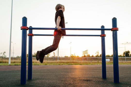 Adolescent exercising on parallel bars