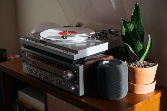 White record spinning on a vintage record hutch.