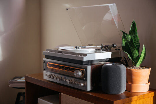 White record spinning on a vintage record hutch.