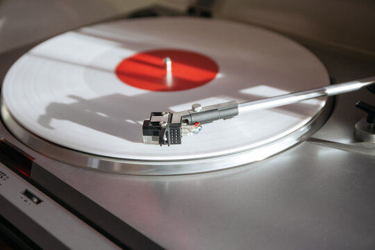 White record spinning on a vintage record hutch.