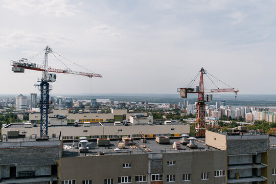 two building cranes above the city line