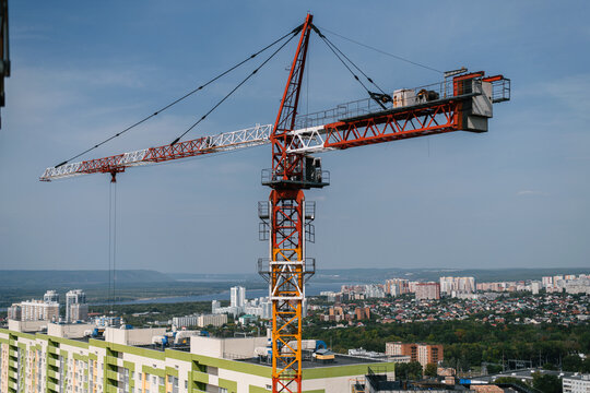 giant building crane above the city line on a sunny day