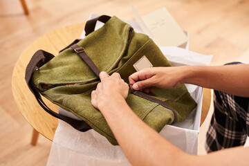 Crop customer checking new bag