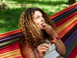 Woman with snack in hammock
