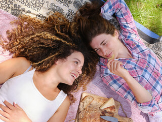 Happy girlfriends with picnic snack