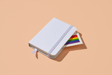 rainbow flag peeking out from a notebook