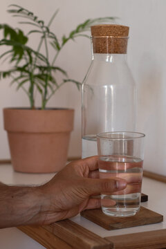 Hand holding a water glass