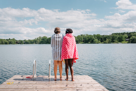 Diverse friends on a deck by a lake