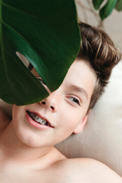 A young boy with dental brackets.