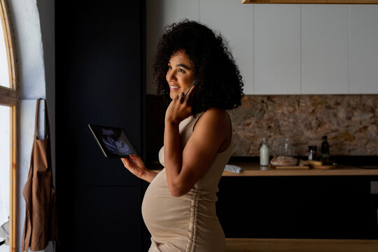 Excited pregnant woman looking a baby ultrasound