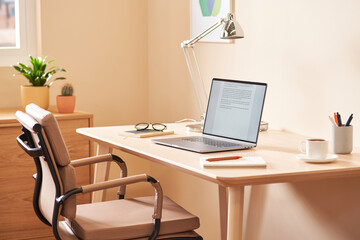 Desk with stationery and laptop