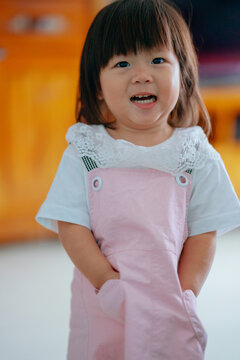 little girl with hands in pockets