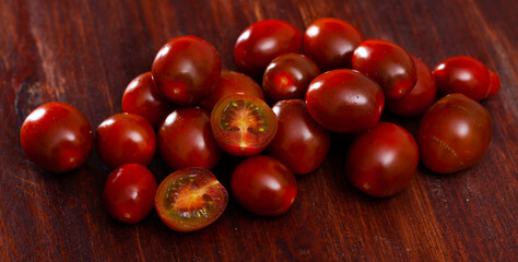 Cooking ingredients, cherry tomatoes on wooden background