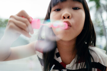 kid playing bubble blowing game