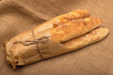 French freshly baked baguette on burlap background