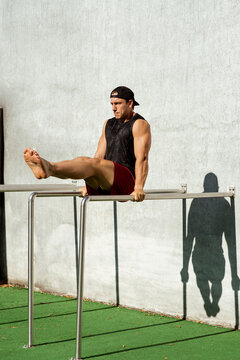 Gymnast performs parallel exercises outdoor.