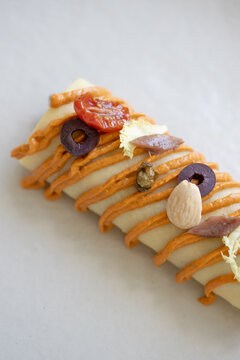 Cold cannelloni with escarole, cod and romesco salad
