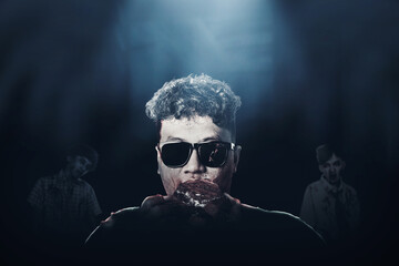 A scary zombie with blood and wound on his body eat the raw meat