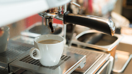 black coffee with milk on a coffee maker