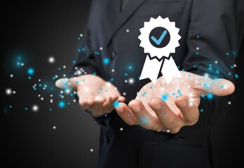 Hand shows the sign of the top service Quality assurance, Standards,