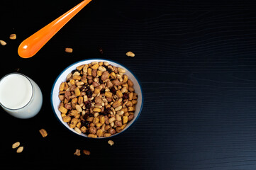 overhead shot of a plate of peanuts with milk