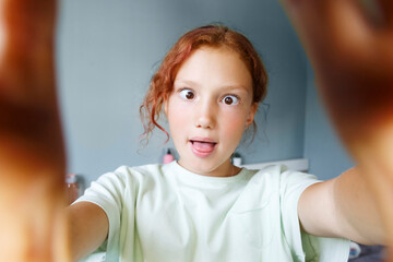 Funny girl taking selfie and grimacing