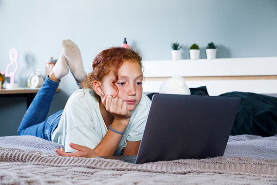 Peaceful girl watching video on netbook