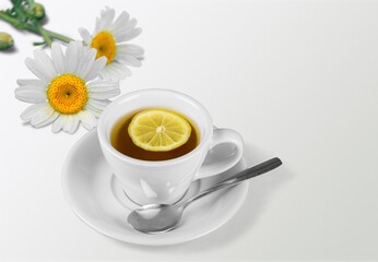 Chamomile tea in a mug with natural small chamomile flowers
