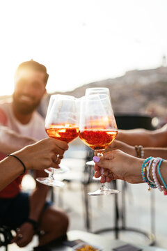 Crop friends proposing toast at party