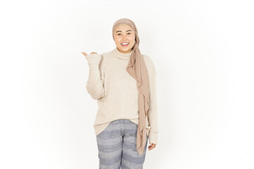 Presenting and Pointing aside with thumb Beautiful Asian Woman Wearing Hijab Isolated On White Background