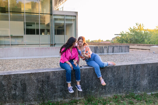 Students using smartphone in college