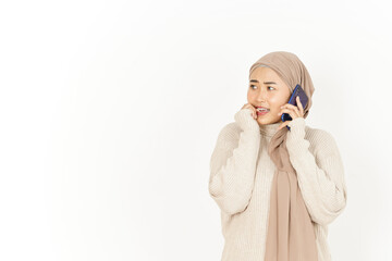 Talking on the Phone with worried expression of Beautiful Asian Woman Wearing Hijab Isolated On White Background