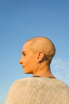 Woman with shaved hair in sunset