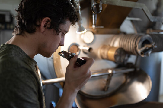 Barista smelling coffee grains