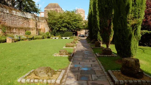 The Chester Roman Gardens in Chester, England UK, bordered by ancient Roman city walls featuring fragments of excavated fortresses