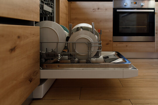 Dish Washer In The Kitchen With Plates