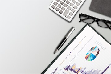 Office workspace. Glasses, notepad, pen, keyboard and paper