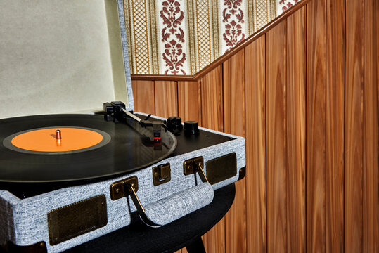 portable turntable playing a vinyl disc