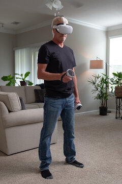 Man using virtual reality set at home.