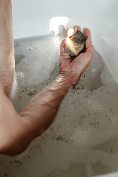 Man with psoriasis bathing with natural soap 