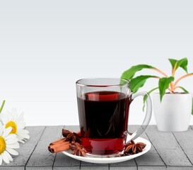 Chamomile tea in a mug with natural small chamomile flowers