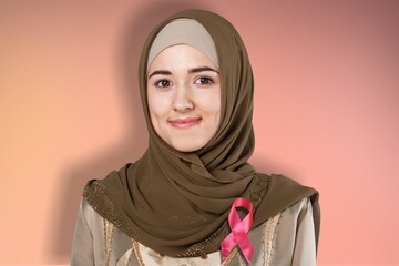 Confident portrait of a friendly Arab Muslim woman wearing a hijab and ribbon