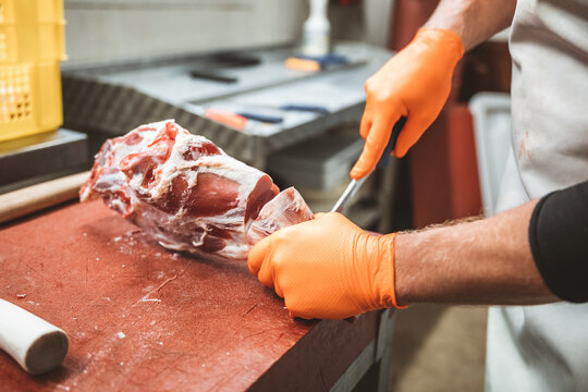man cutting meat