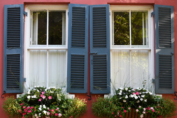 Red House With Navy Shutters And Window Boxes